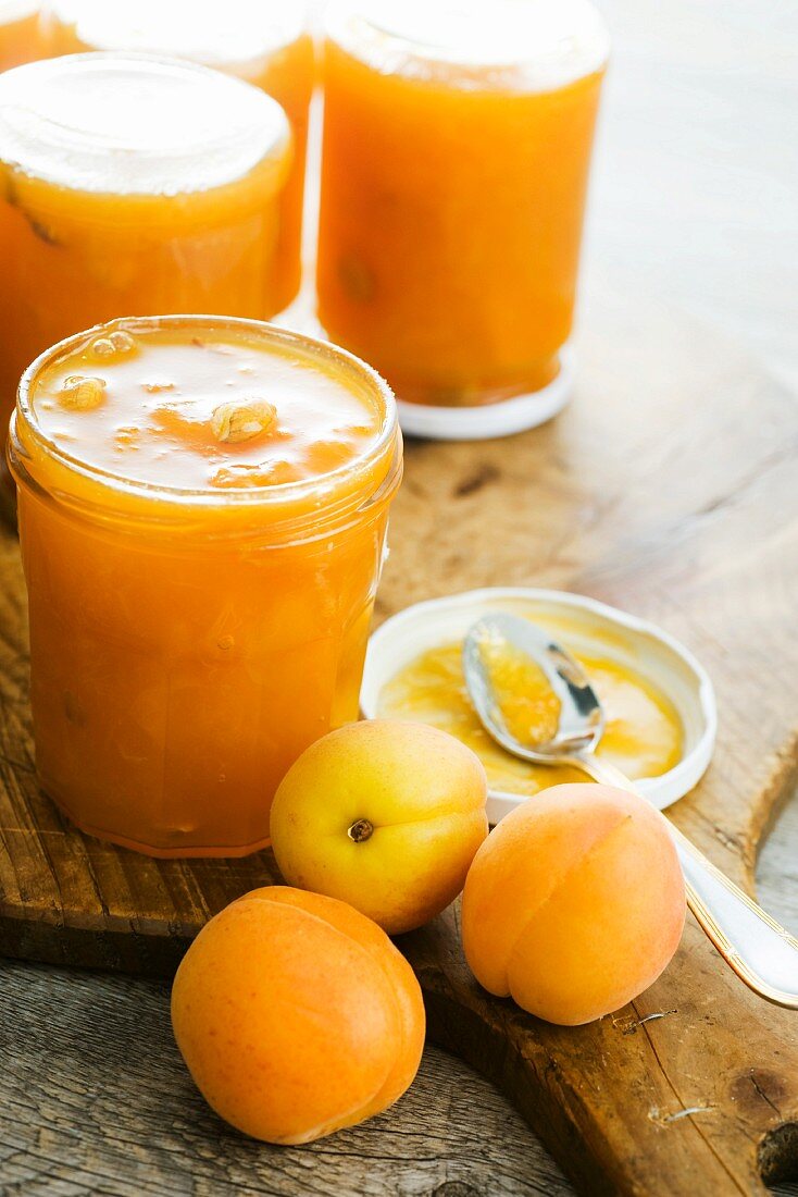 Jars of apricot jam and fresh apricots