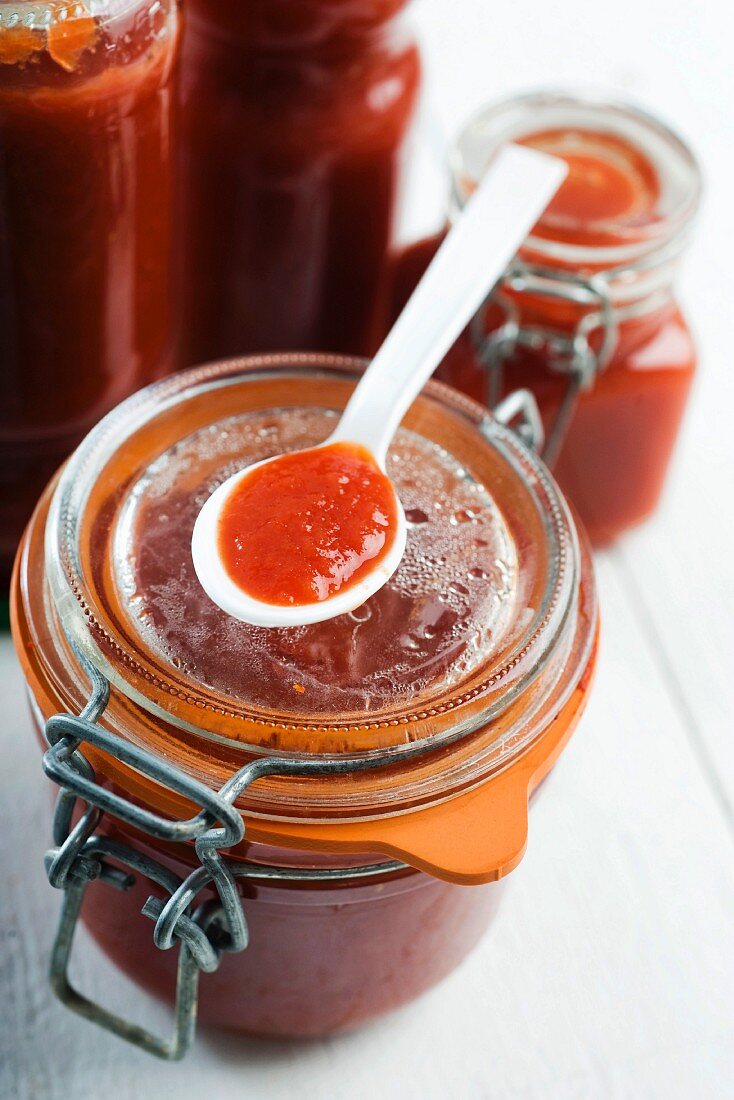 Tomato paste in a jar and on a spoon
