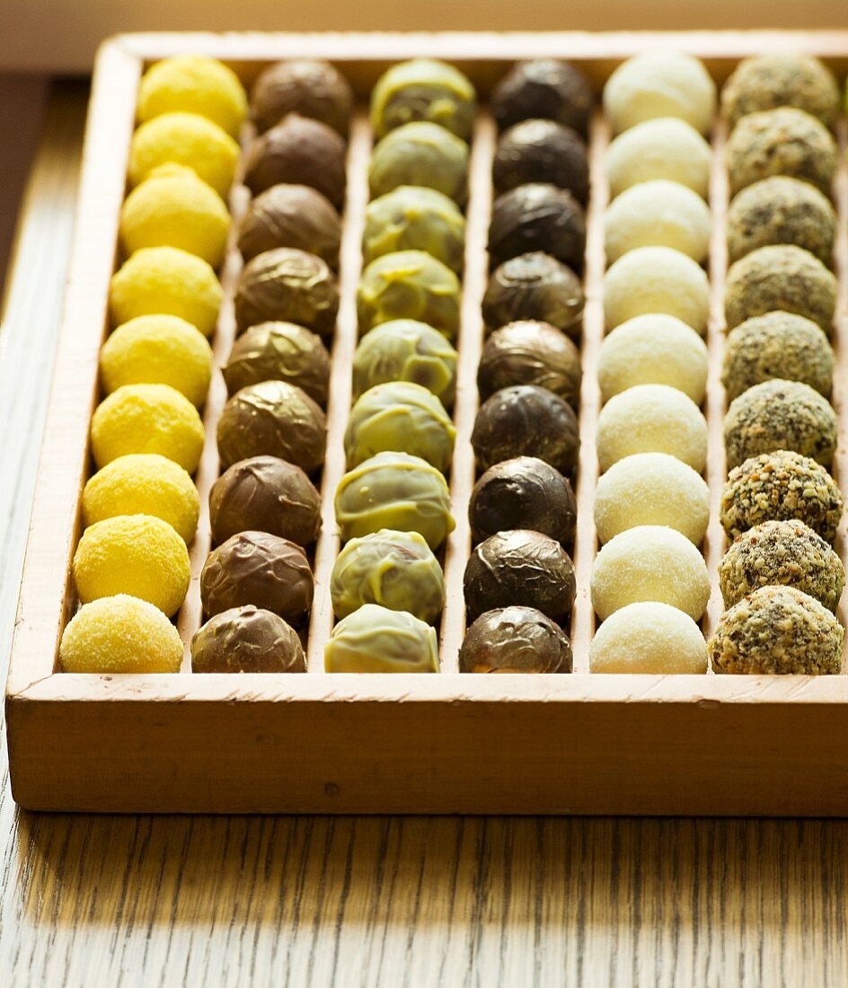 Assorted truffles in a wooden chocolate box