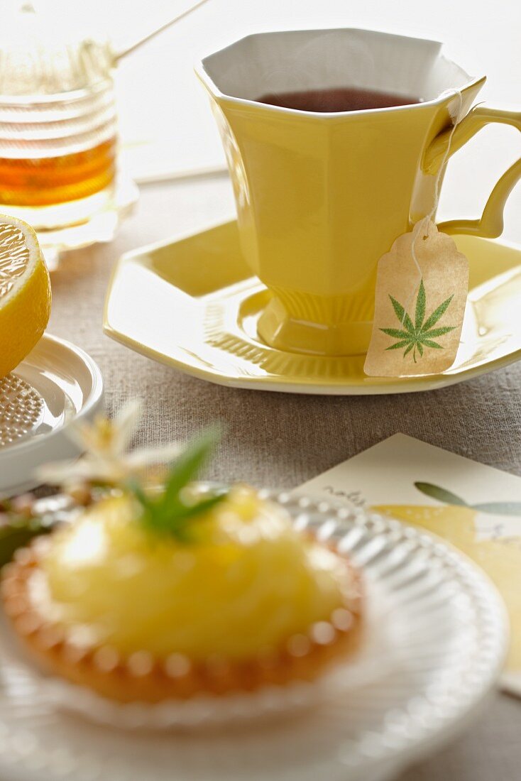 Marijuana Tea in a Yellow Tea Cup; Mini Lemon Pie