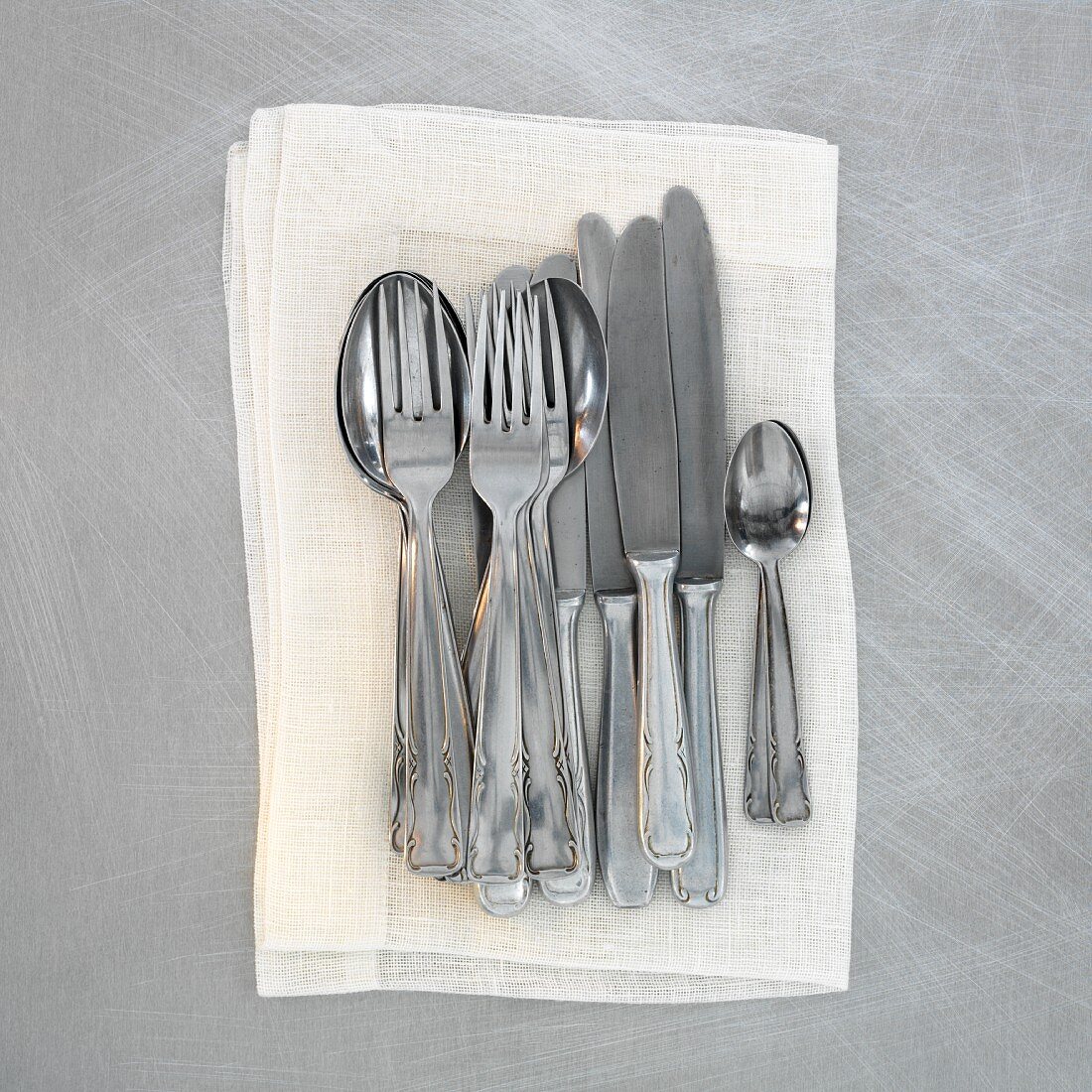 Old cutlery on a napkin (seen from above)