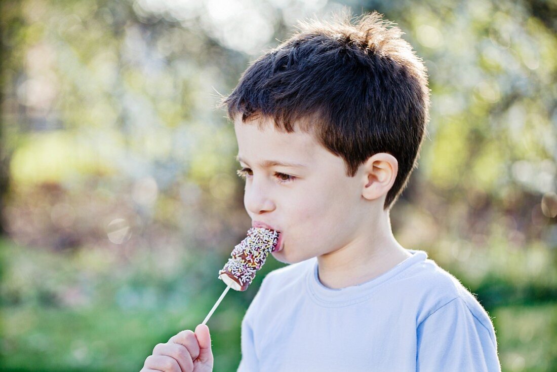 A little boy eating marshmallows