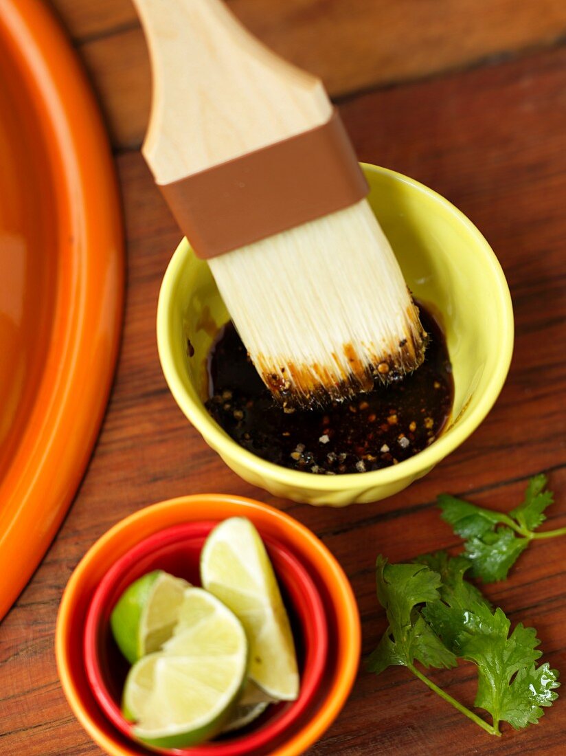 Barbecue sauce in a bowl with a brush