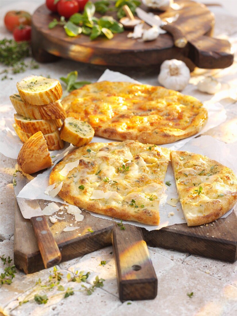 Various types of gratinated unleavened bread and garlic baguette