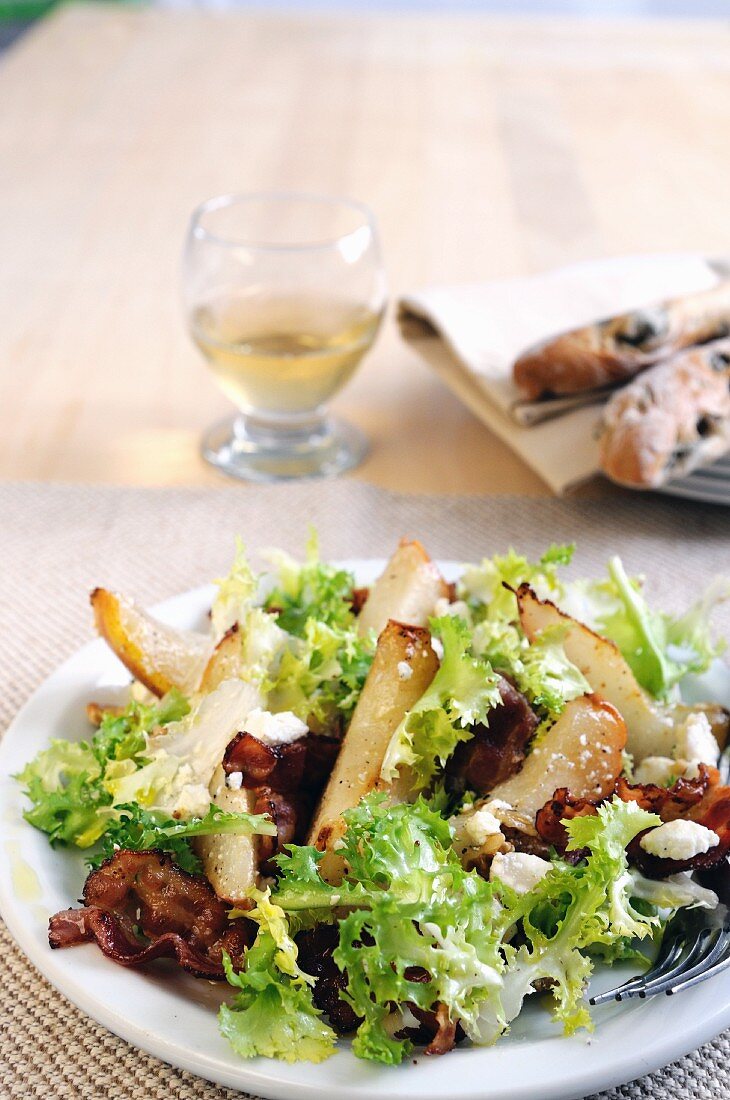 Frisee lettuce salad with pear, feta and fried Pancetta