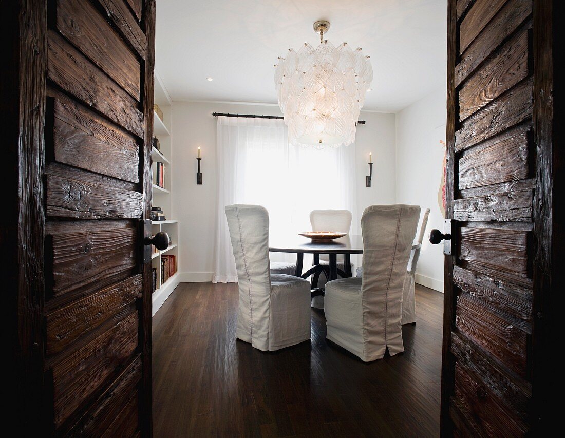 View through wooden double doors to dining room