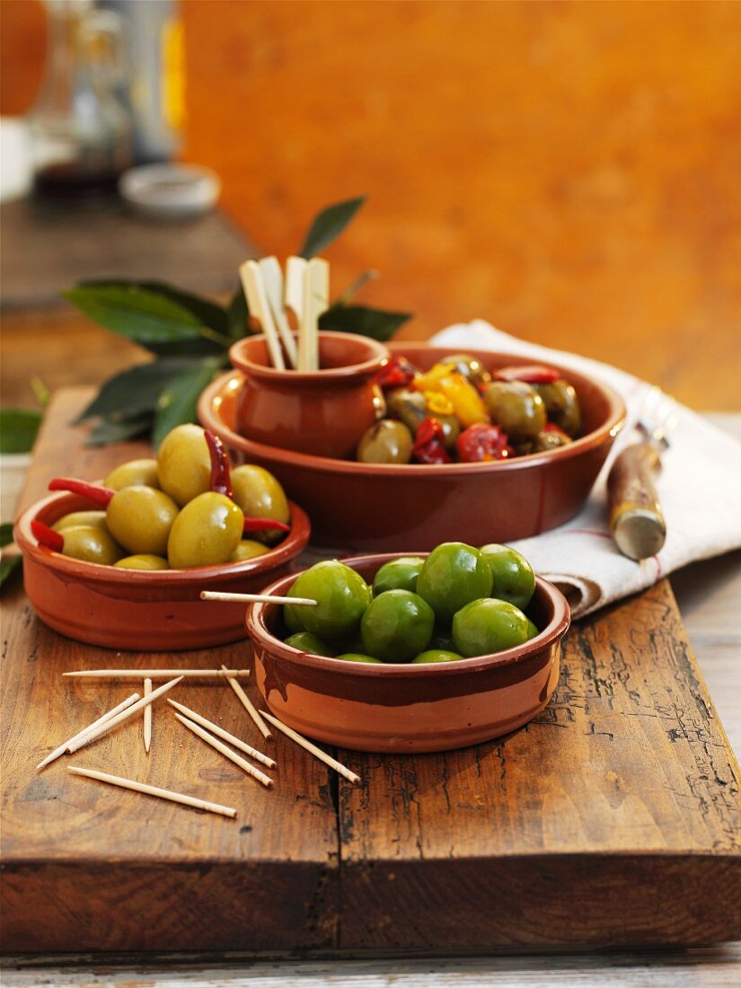 Various different types of olives in bowls