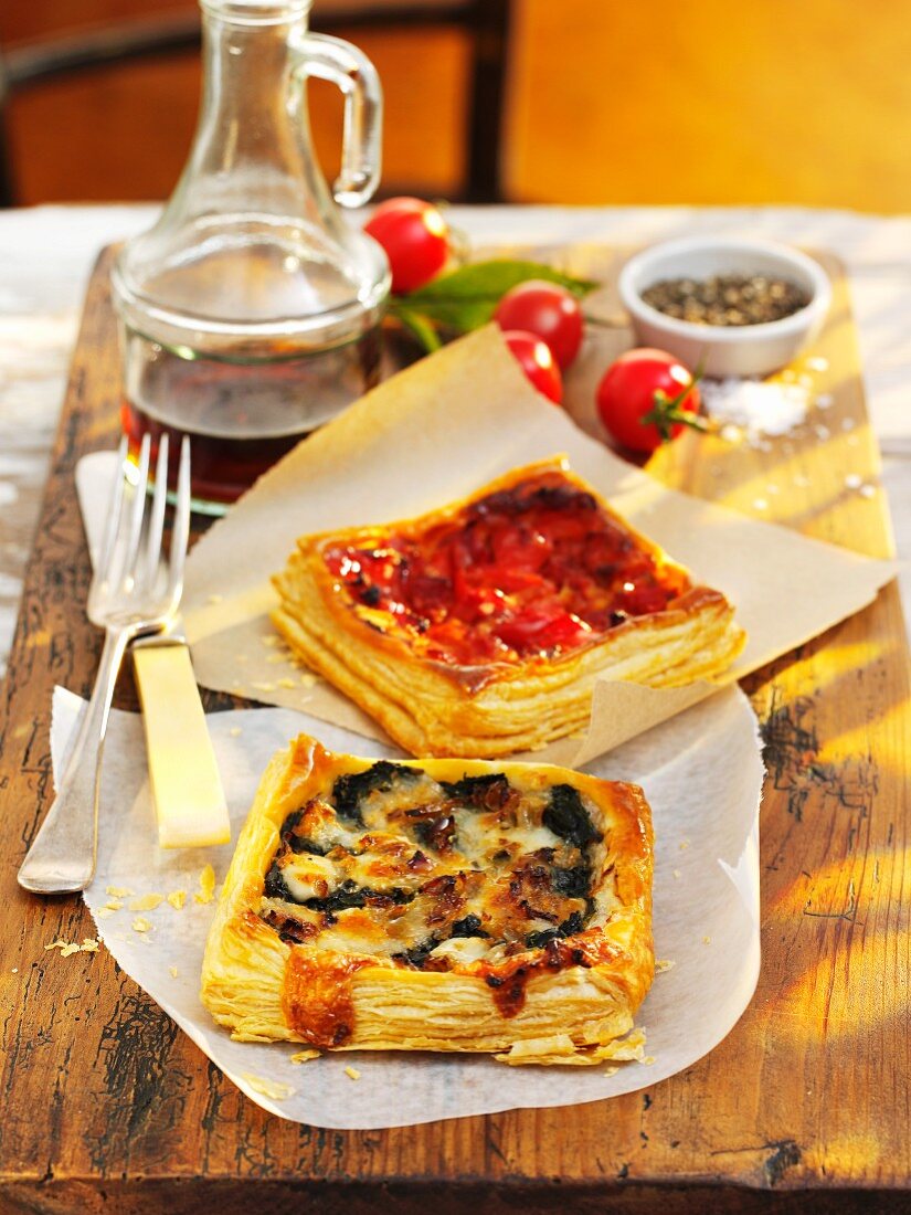 Spicy puff pastry tarts on a wooden board