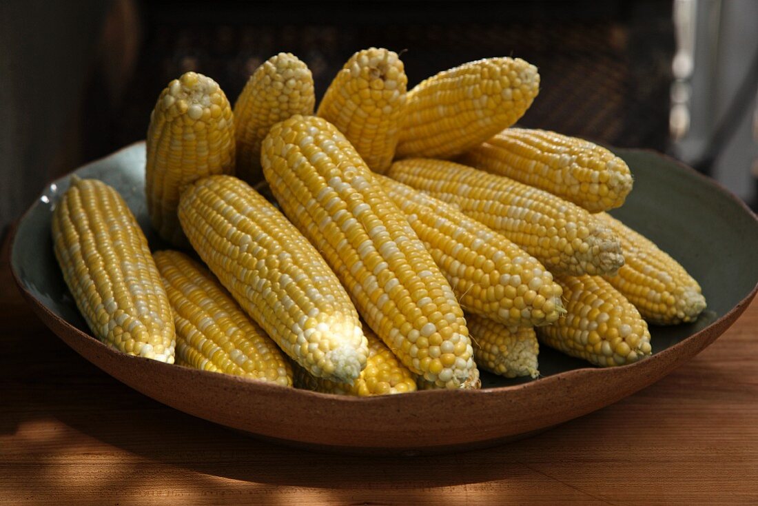 Ears of Shucked Organic Corn Cobs in a Bowl