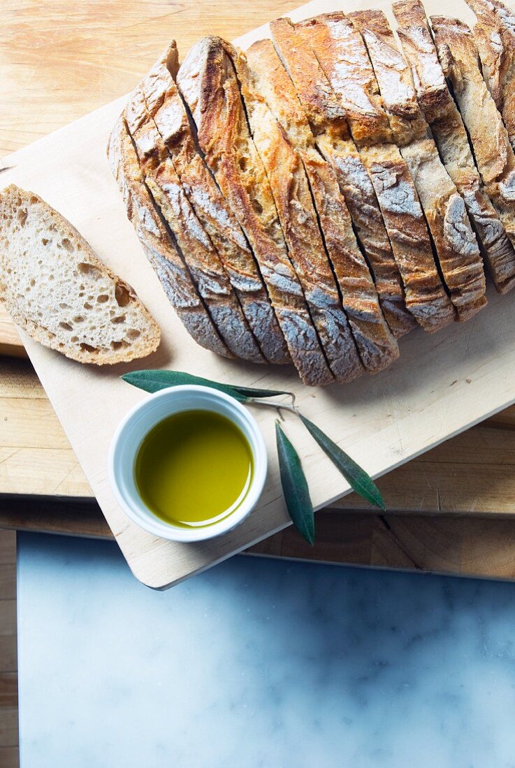Rustic Loaf of Organic Spelt Bread with a Bowl of Ectra Virgin Olive Oil for Dipping; From Above