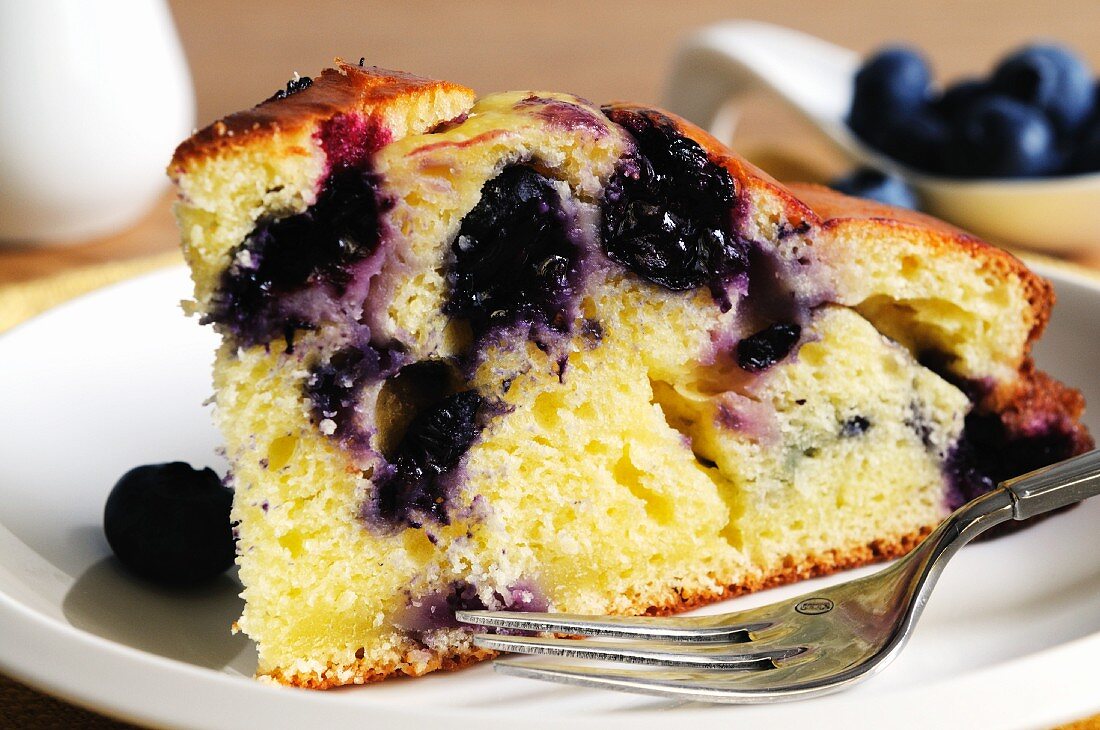 A slice of ricotta and blueberry cake (close-up)