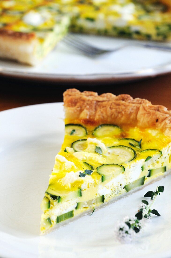 A slice of courgette and ricotta quiche on a plate