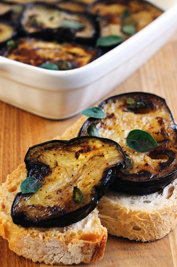 Slices of baguette topped with marinated aubergine slices