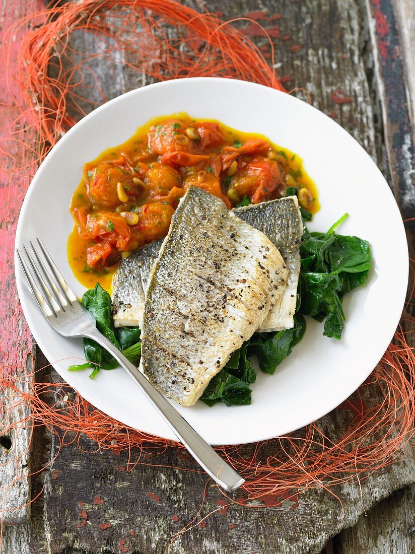 Sea bass with tomatoes and spinach