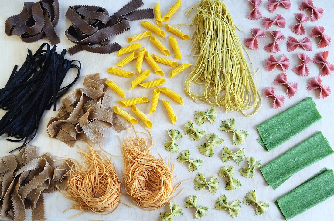 An arrangement of various colourful types of pasta