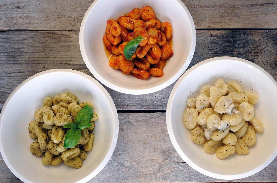 Fresh gnocchi with three different sauces (seen from above)
