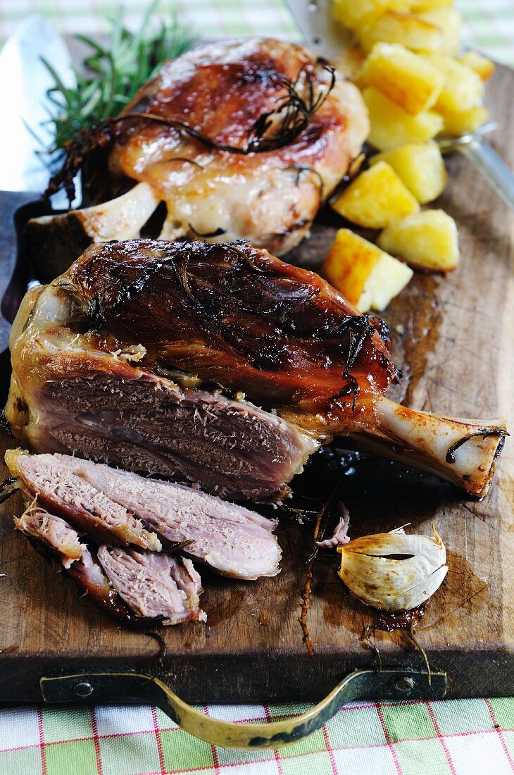 Pork knuckle with potatoes on a chopping board