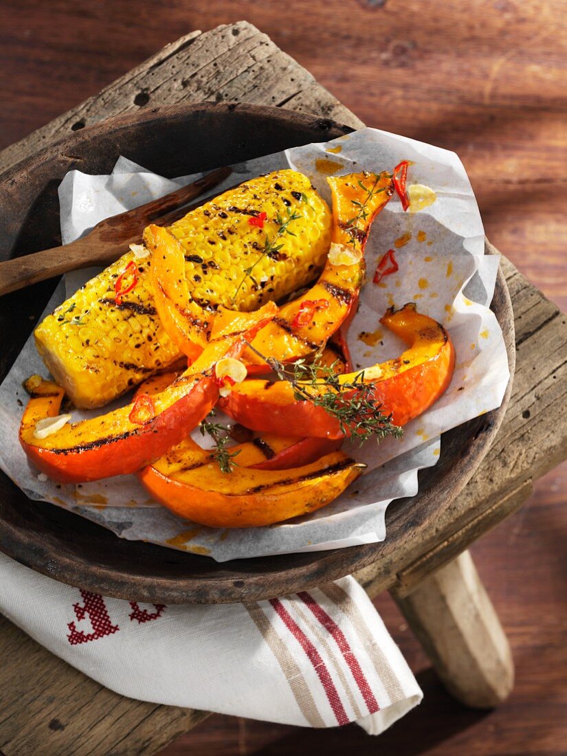 Grilled pumpkin and corn cobs