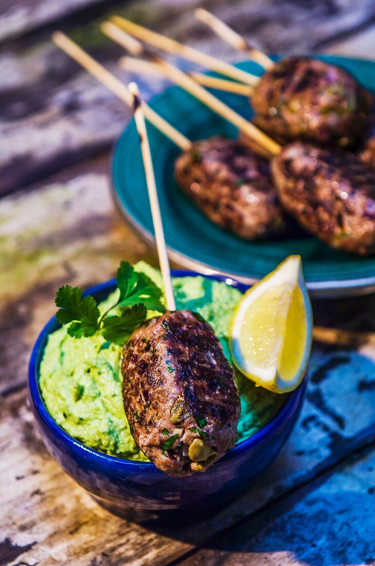 Meat kebabs with a broad bean puree
