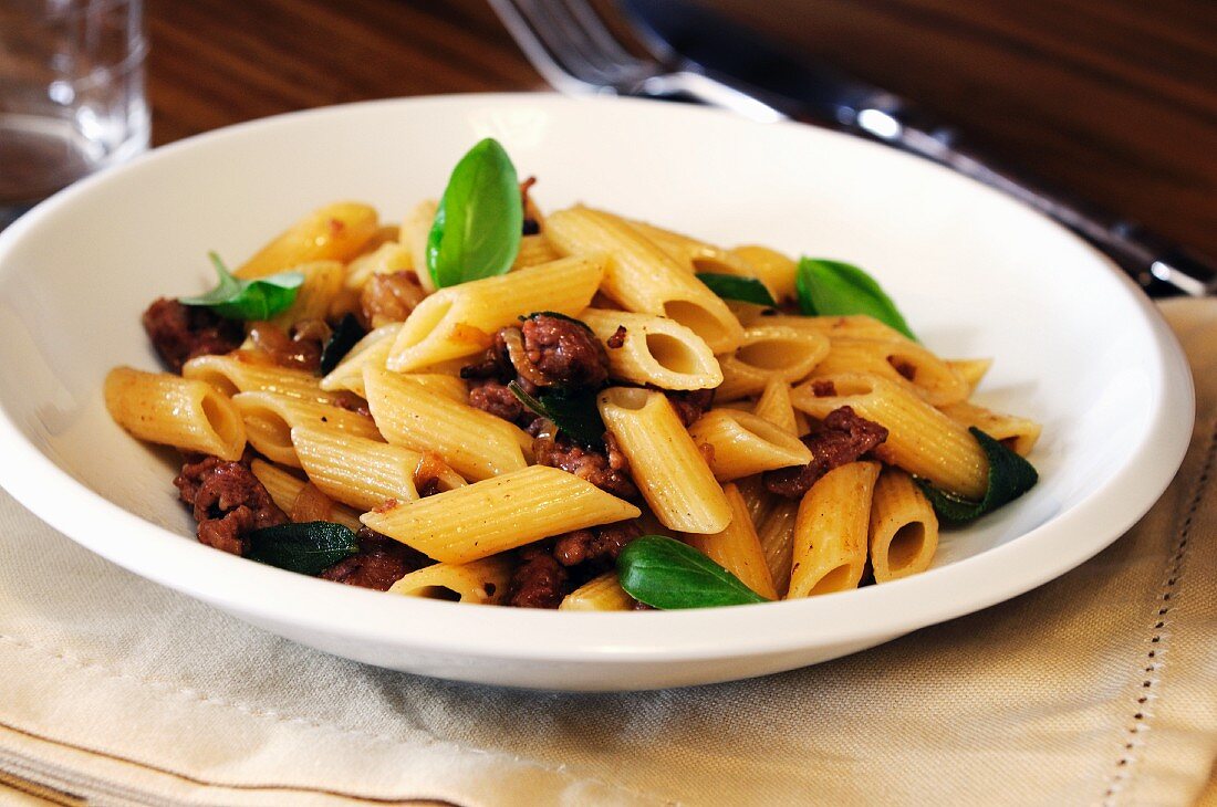 Penne pasta with sausage and basil