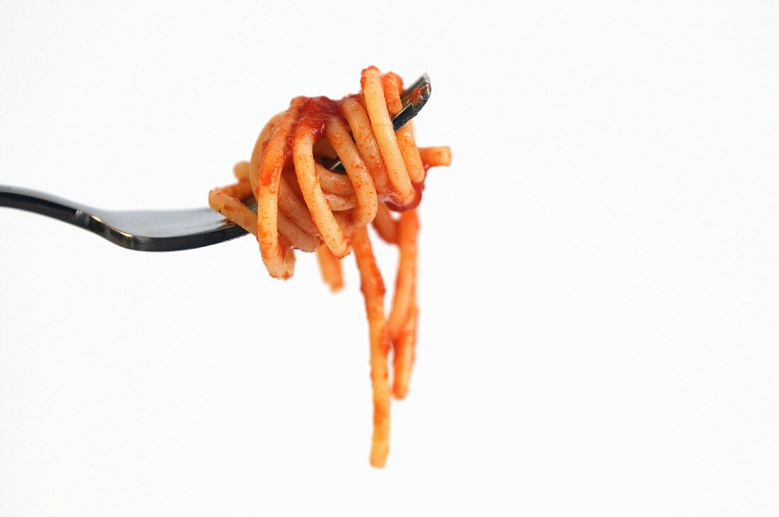 A fork of spaghetti with tomato sauce