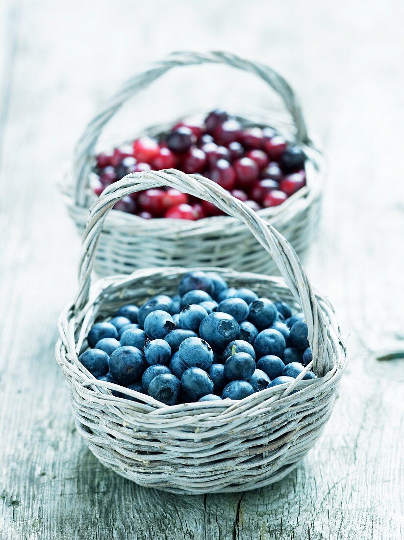 Blueberries and cranberries in baskets