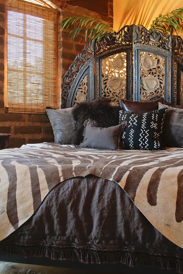 Brown African printed bedding on bed