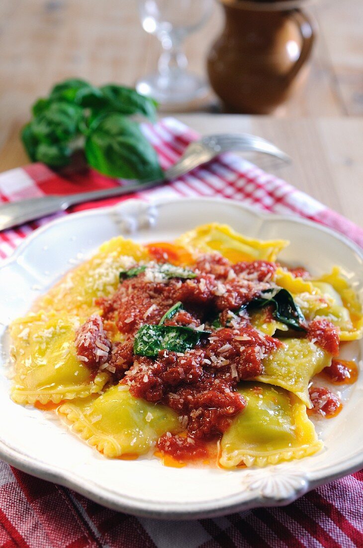 Spinach and ricotta filled ravioli pasta with tomato and fresh basil sauce