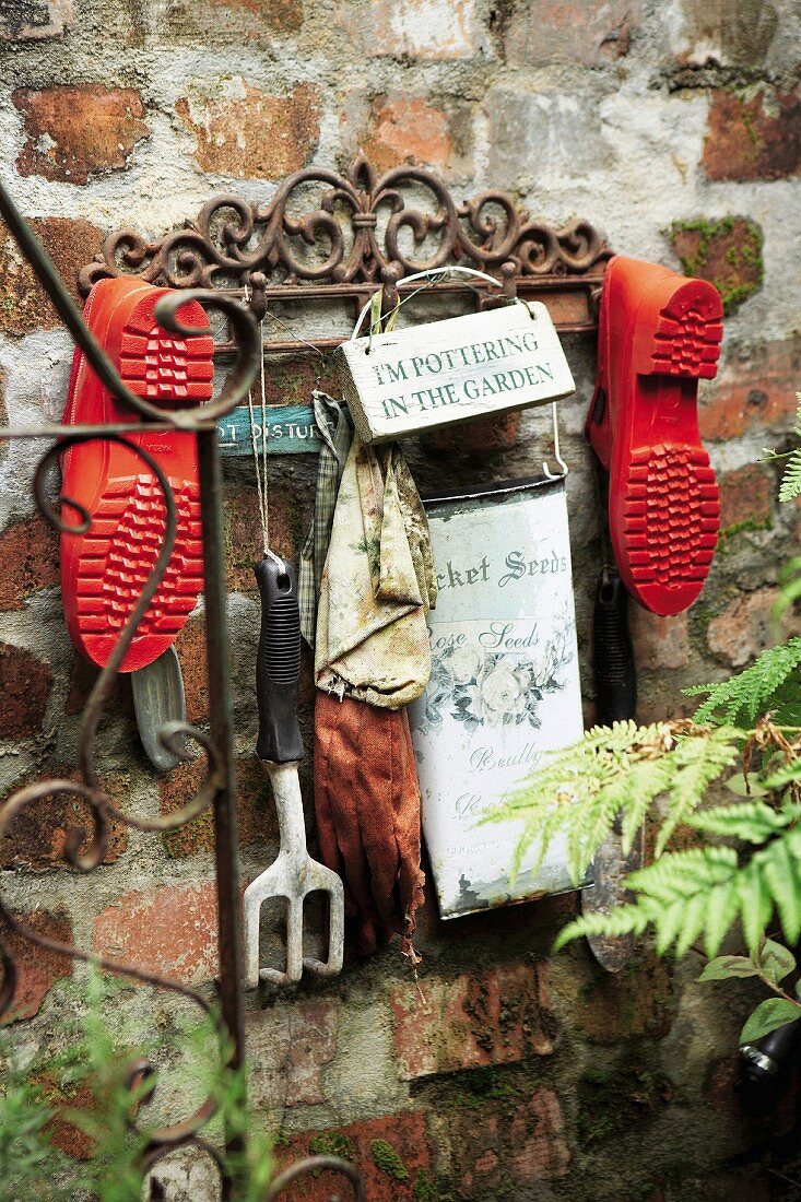 Garden tools and shoes hanging in the courtyard