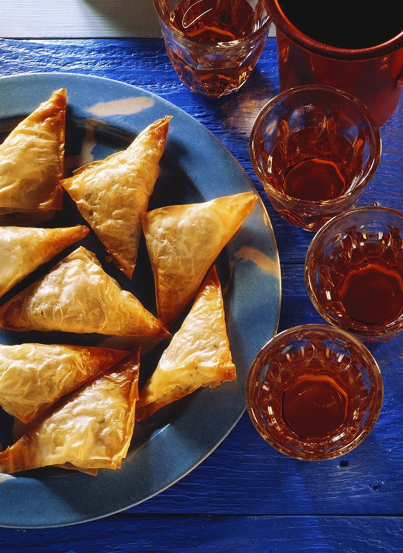 Cheese pasties on plate; decoration: filled glasses