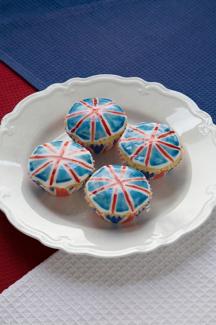Four Union Jack Cupcakes on a White Plate