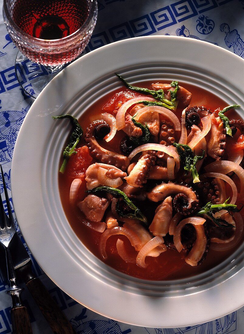 Octopus in wine with tomatoes, onions and fennel leaves