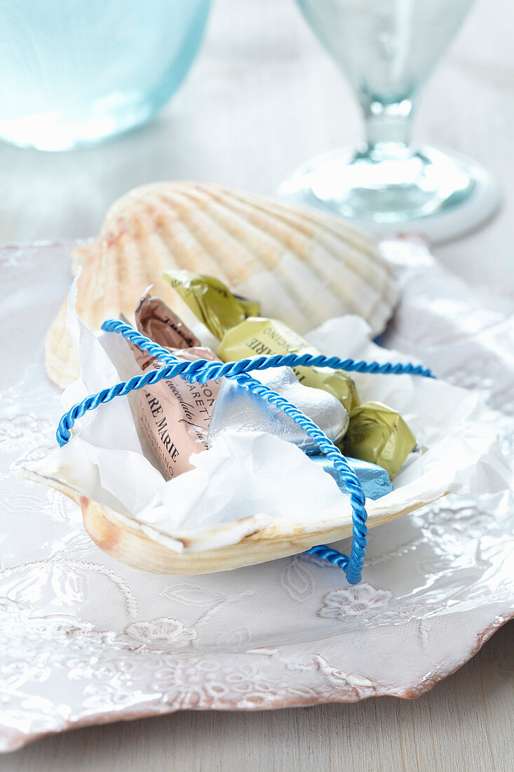 Small present: scallop shell dish of sweets tied with cord