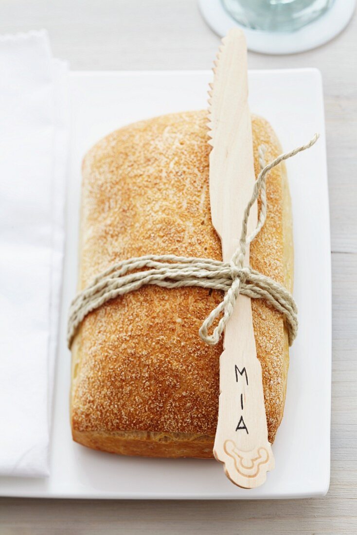 Bread roll and bamboo knife used as name card