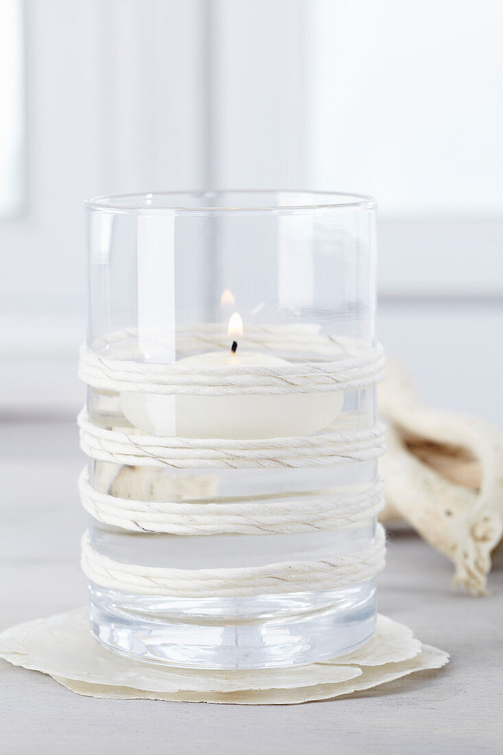 Floating candle in glass decorated with twine