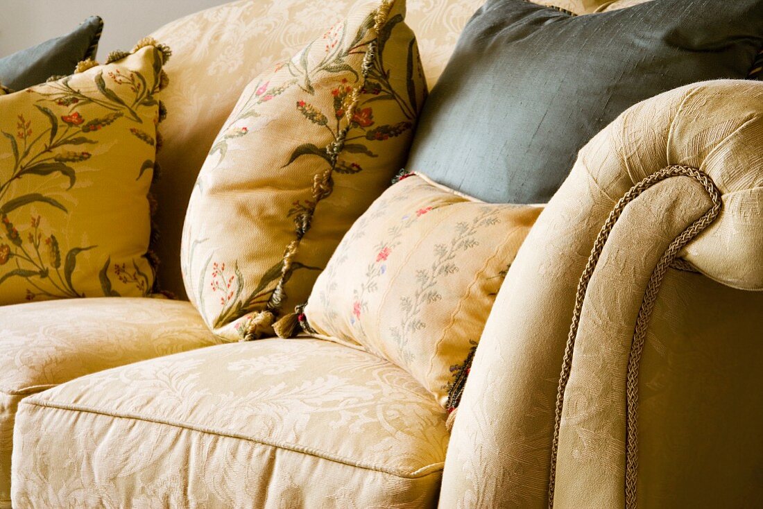Floral cushions on traditional upholstered sofa