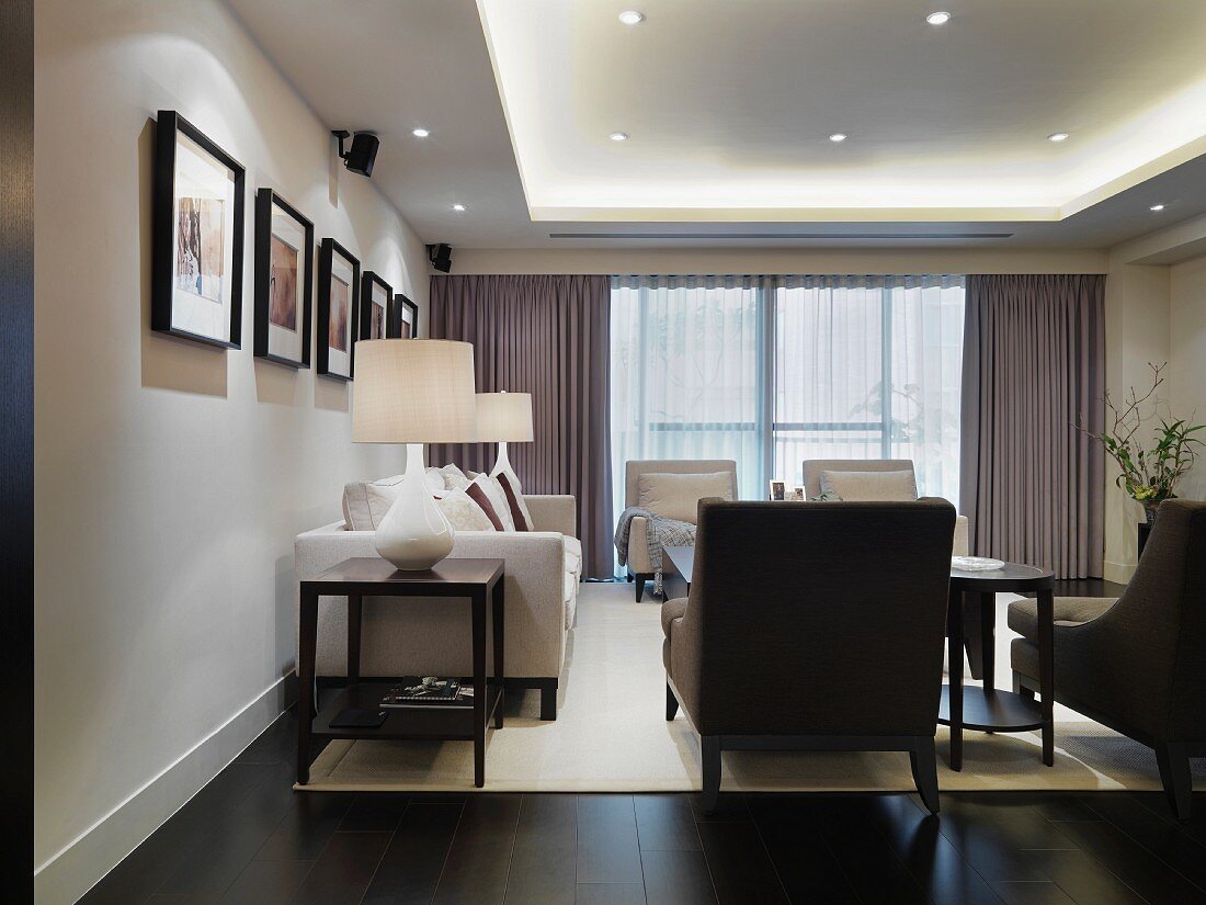 Elegant interior with classic, upholstered suite and modern, indirect lighting