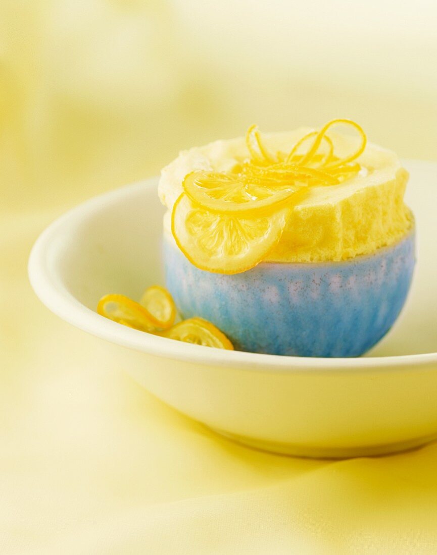 Lemon Souffle with Sliced Candied Lemons and Lemon Peel in a Blue Bowl
