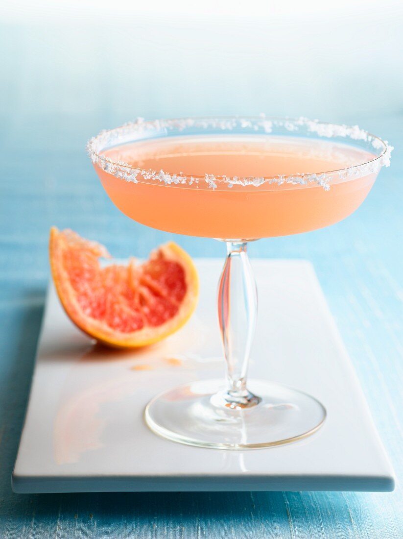 Grapefruit Martini in a Glass with Sugared Rim; Squeezed Grapefruit