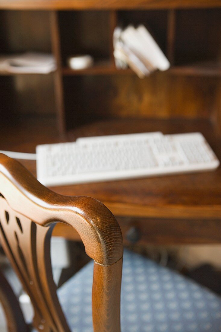 View of a desk from behind the chair close up