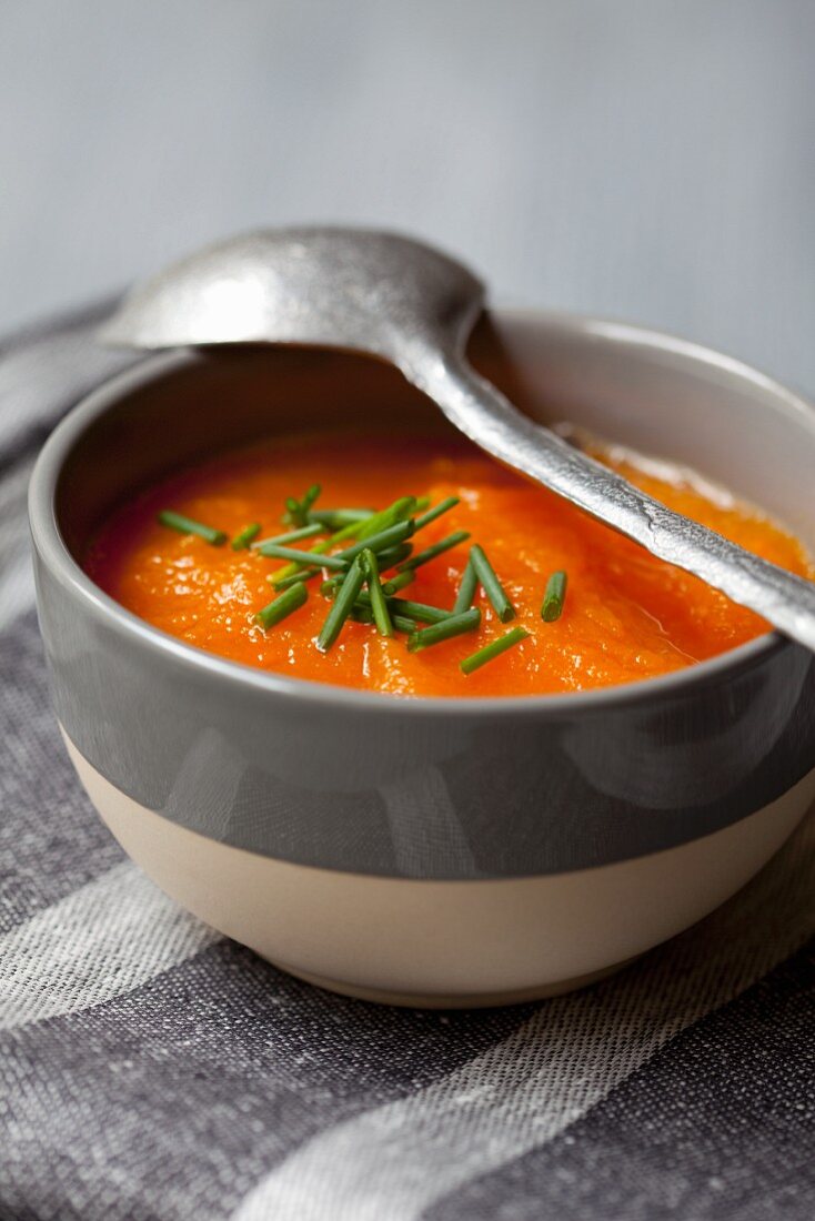 A bowl of carrot and pumpkin soup