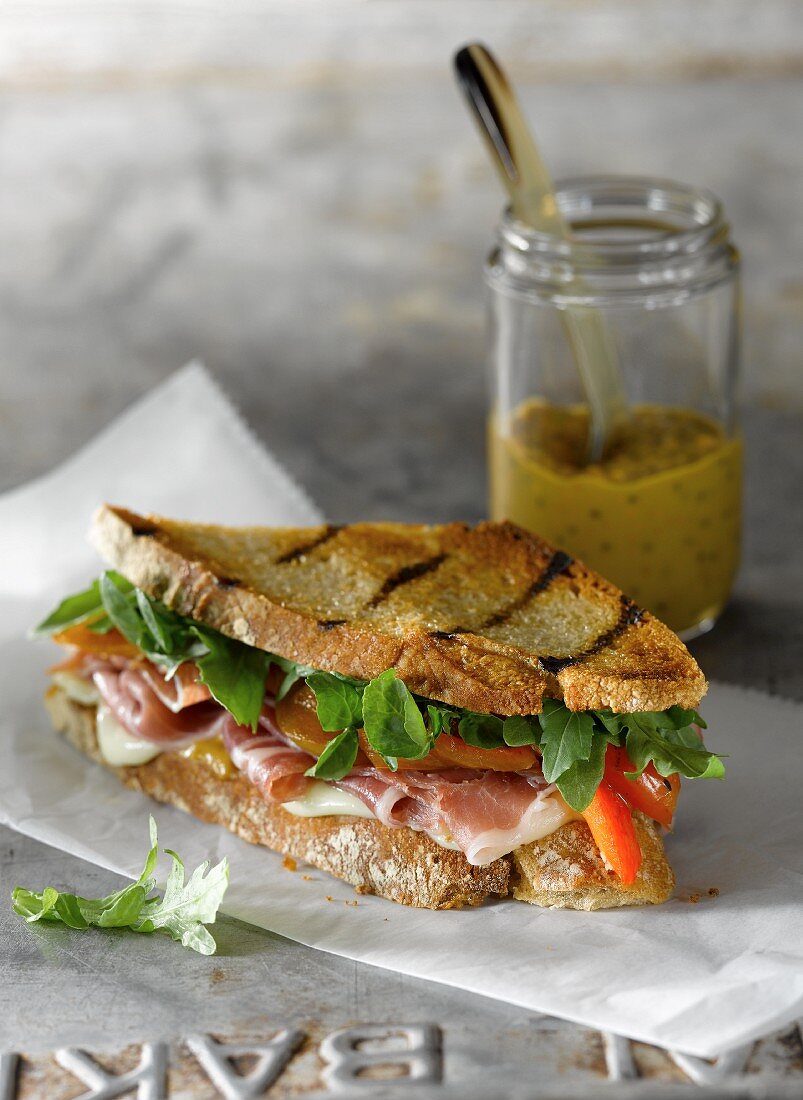 Grilled Prosciutto and Cheese Sandwich with Roasted Red Peppers and Arugula