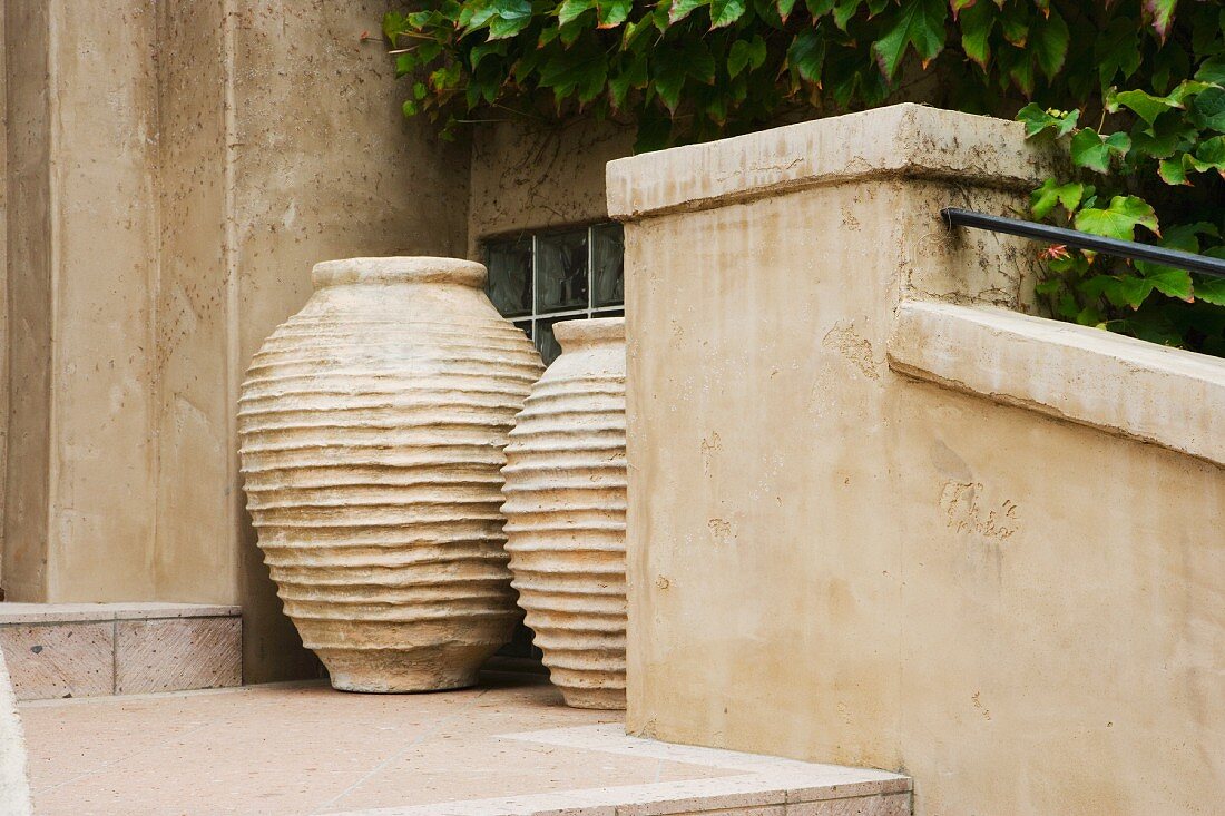 Vignette of two large clay pots.