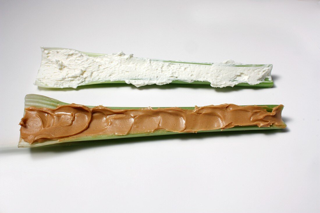 Two Pieces of Celery; One with Peanut Butter and One with Cream Cheese