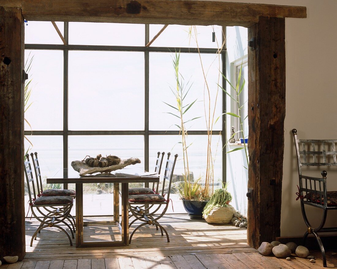 Dining table in rustic extension with glazed facade