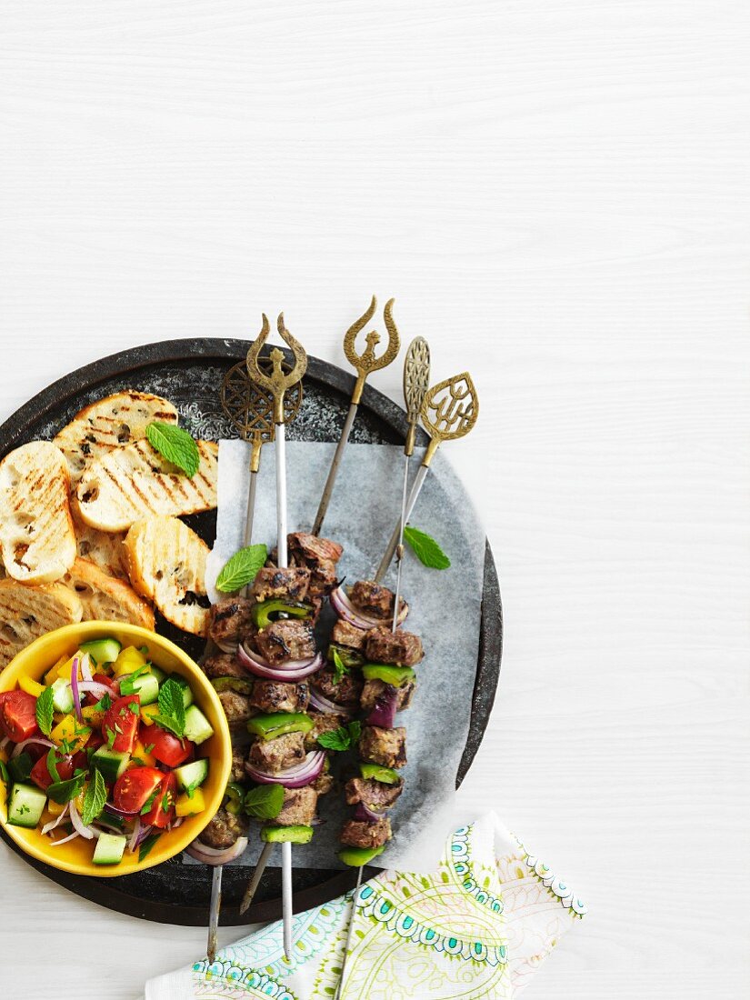 Lamb kebabs with vegetable salad and grilled bread (Turkey)