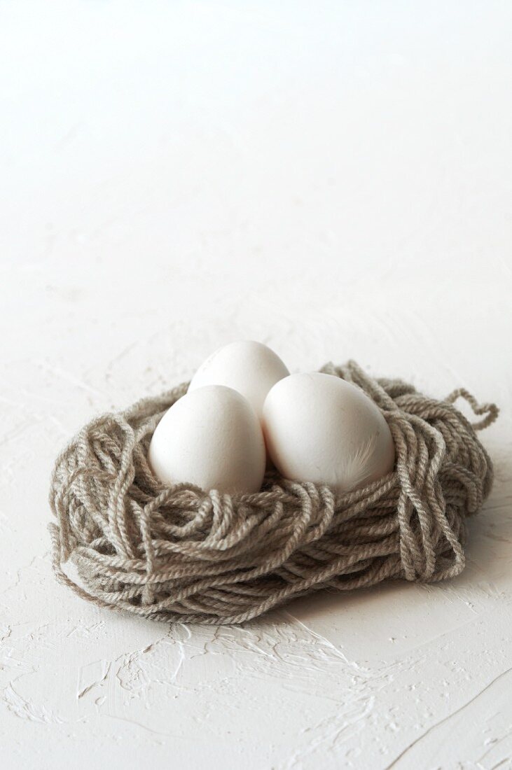 Three eggs in a nest of wool