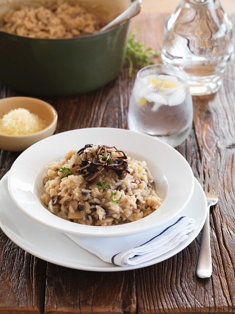 Mushroom risotto, iced water and grated Parmesan