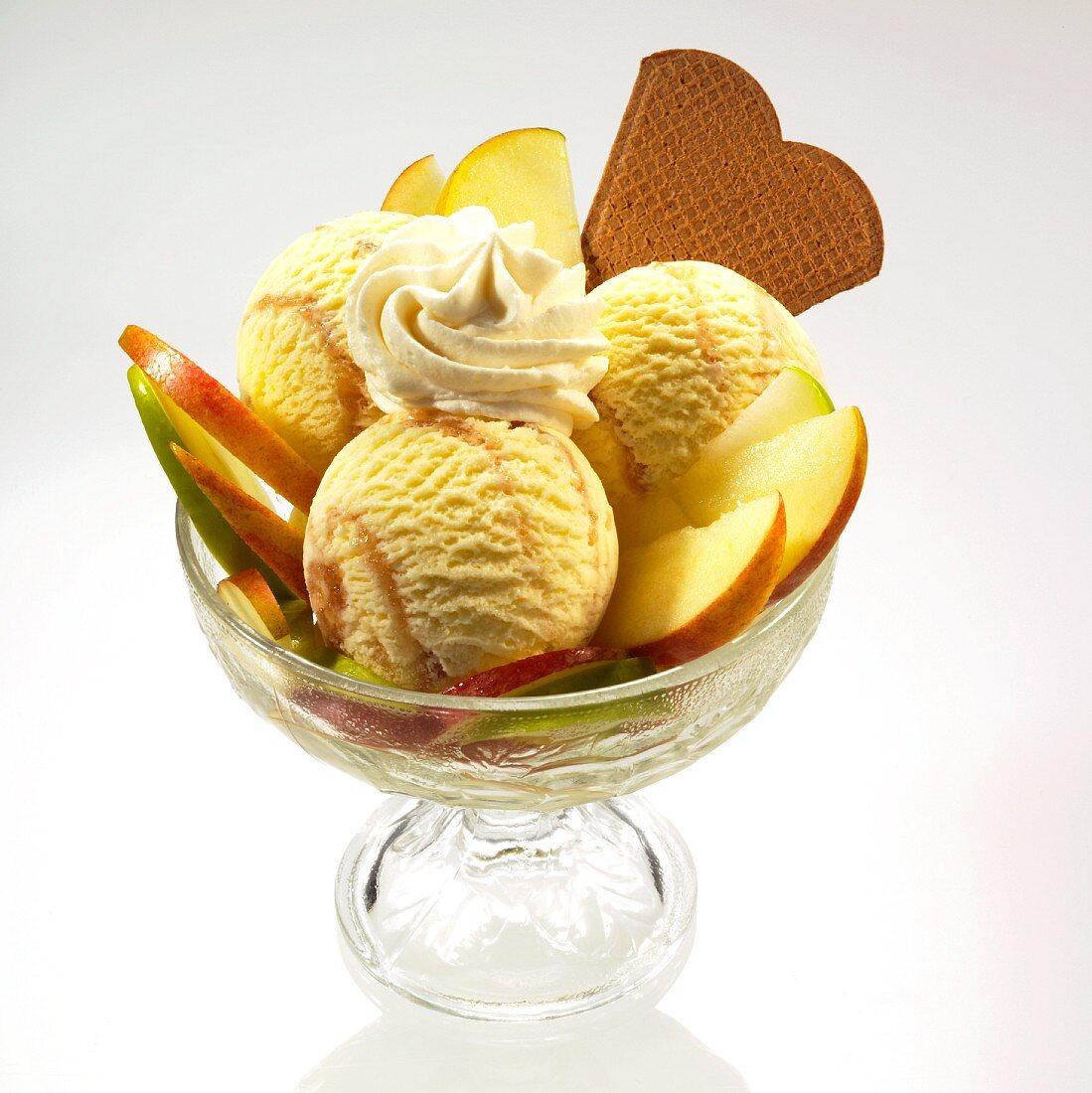 An apple ice cream sundae with cream and wafers