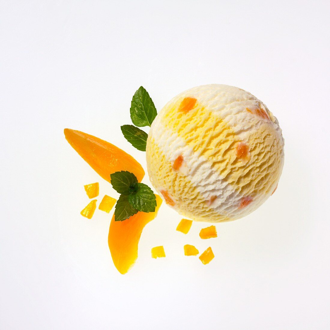 A scoop of apricot and yogurt ice cream, apricot wedges and lemon balm